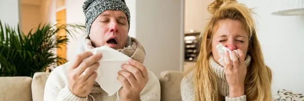 Sick couple catch cold. Man and woman sneezing, coughing. People got flu, having runny nose